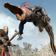 A screenshot from God of War Ragnarok depicting Kratos fighting a big alligator-looking beast.